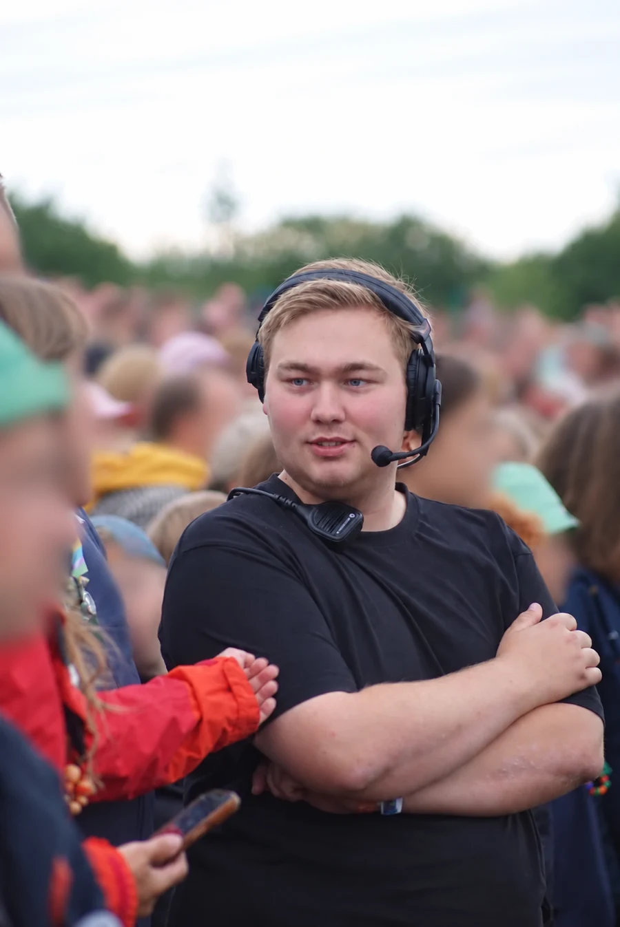Jakob wearing a communications headset at an outdoor event.